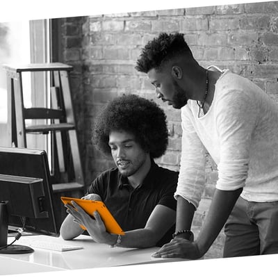 Two young professional men looking at a tablet computer