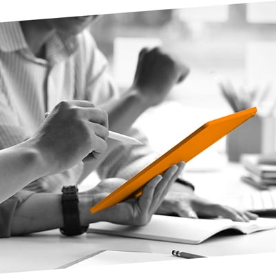 Two businessmen collaborating on a tablet