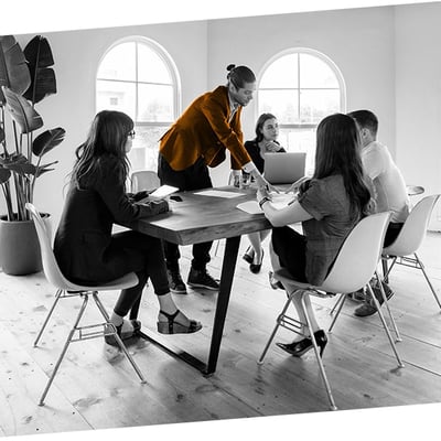 Confident man presenting to a group of young business people