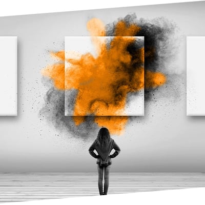 Woman looking at concept art with and orange paint explosion