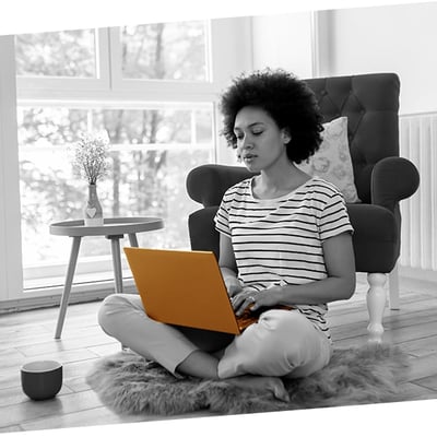 woman working from home sat on the floor cross legged