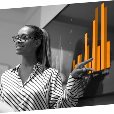 Woman Confidently Presenting Data on a Large interactive screen